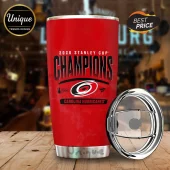 Carolina Hurricanes 2026 Stanley Cup Champions red stainless steel tumbler with matching clear sliding lid on wood table.!