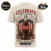 Off-white t-shirt with Coca-Cola bottle graphic, American flag shield, fireworks, and text Celebrate The Legacy 1776-2026.!