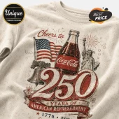 Off-white t-shirt featuring a Coca-Cola bottle, American flag, Liberty Bell, and Statue of Liberty with 250 years text.!