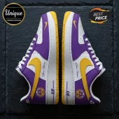 Custom Nike Air Force 1 sneakers in purple, white, and yellow with LA palm tree basketball logo on a slate background.!