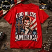 Red graphic t-shirt featuring David Bowie with lightning bolt makeup, a cross, and American flag motif text God Bless America.!
