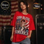 Red cotton t-shirt featuring a graphic of David Bowie with a lightning bolt, a cross, and American flag print text.!