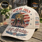 Cream colored baseball cap featuring a Def Leppard leopard graphic, American flag, fireworks, and 1776 USA text on wood.!