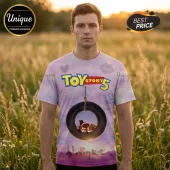 Man wearing a pastel tie-dye t-shirt featuring Toy Story 5 text, a hanging tire graphic, and silhouettes of Woody and Jessie.!