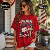 Woman wearing oversized red cotton t-shirt with God Bless America, Dr. Pepper logo, American flag, and wooden cross graphic.!