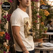 Man wearing an off-white cotton t-shirt featuring a graphic of Elton John playing piano with the text Shine bright enough.!