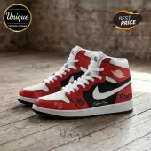 Custom red, white, and black high-top sneakers with graffiti-style text on a wooden floor background.!