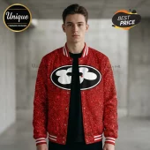 Man wearing a red sequin varsity jacket with white striped ribbed trim and a circular black patch featuring white flowers.!