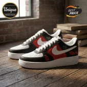 Custom black, red, and white sneakers with Future and The Real Me graffiti text on a wooden floor near brick wall.!