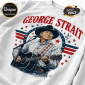 George Strait graphic t-shirt featuring the singer in a cowboy hat playing guitar with American flag star motifs.!