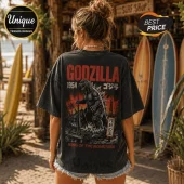 Black vintage-wash t-shirt with a 1954 Godzilla graphic, Japanese text, and King of the Monsters lettering on the back.!