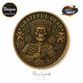 Grateful Dead gold-tone metal collector coin featuring a skeleton wearing sunglasses and playing an acoustic guitar.!