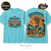 Light blue mineral wash t-shirt featuring Grateful Dead tropical skeleton surfing graphic on front and back.!