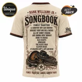 Cream-colored t-shirt with Hank Williams Jr. song titles, a black cowboy hat, acoustic guitar, and coiled rope graphic print.!