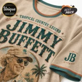 Beige cotton t-shirt with Jimmy Buffett graphic, teal lettering, palm trees, rope border, and ribbed teal-orange collar.!