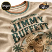 Beige cotton t-shirt featuring Jimmy Buffett portrait, palm trees, and Tropical Country Legend text in teal and orange.!