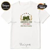 White t-shirt featuring a green John Deere tractor graphic with wheat stalks, five stars, and America 250 1776-2026 text.!