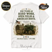 White t-shirt featuring a green John Deere tractor, barn, American flag, wheat stalks, and 250 years anniversary text.!
