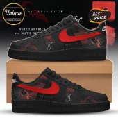 Black Nike Air Force 1 sneakers with red swoosh and Joji Solaris Tour graphic print, displayed on a cardboard shoe box.!