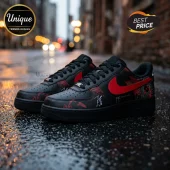 Black leather low-top sneakers with red side swooshes, red splatter patterns, and Solaris Tour text on a wet city street.!