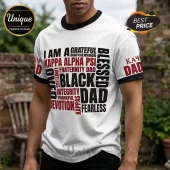 White ringer t-shirt featuring Kappa Alpha Psi fraternity typography in black and red text, worn by a man outdoors.!