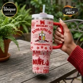Pink Stanley tumbler featuring red Kappa Alpha Psi fraternity branding, logos, and 1911 text held by a hand outdoors.!