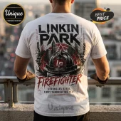 White t-shirt showing back print of Linkin Park logo, a firefighter helmet, city skyline, and text Strong as steel.!