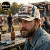 Beige baseball cap featuring a bald eagle, American flag print, and Southern Rock & Roll text on a blurred outdoor venue.!