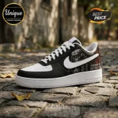 Black and white leather sneaker with a skull graphic and text reading Symphony of Destruction on a cobblestone street.!