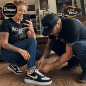 Woman wearing Megadeth graphic t-shirt and custom black-and-white sneakers with Megadeth branding tied by a man.!