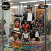 Michael Jackson figurine collection featuring various outfits on a colorful circular base labeled King of Pop.!