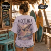 Light purple cotton t-shirt with Mothra graphic, sunset beach scene, tropical palm trees, and Japanese text on the back.!