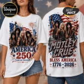 White t-shirt featuring Mötley Crüe band members, American flag, fireworks, Statue of Liberty, and 1776-2026 text graphics.!