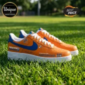 Custom orange and blue New York Knicks themed leather sneakers with white soles sitting on green grass.!