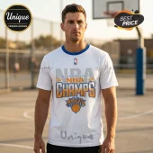 Man wearing a white cotton crewneck t-shirt with 2026 NBA Champs Knicks logo graphic, featuring blue collar trim on basketball court.!