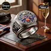New York Knicks 2026 NBA championship ring with silver band, blue and orange enamel accents, and inlaid clear gemstones.!