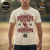 Cream-colored cotton t-shirt featuring maroon Oklahoma Sooners 2026 National Champions baseball graphic and NCAA logo.!