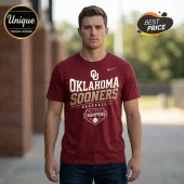 Man wearing crimson Oklahoma Sooners baseball shirt with white and gold text and 2026 National Champions graphic.!