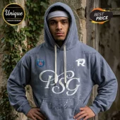 Man wearing a slate blue Paris Saint-Germain hoodie with white splatter paint design, logo patch, and white drawstrings.!