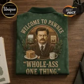 Dark green polo shirt featuring Ron Swanson, waffles, and the text Welcome to Pawnee and Whole-ass one thing.!