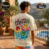 Man wearing an oversized cream t-shirt with a colorful M&M's pool party graphic print on the back.!