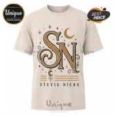 Beige cotton t-shirt with gold and black vintage-style typography reading SN and Stevie Nicks with celestial moon motifs.!