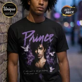 Black cotton t-shirt featuring Prince portrait, purple smoke, flying white doves, and the lyrics I only want to see you laughing in the purple rain.!