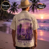Man wearing a cream button-down shirt with a purple guitar, microphone, and sunset graphic labeled Old School Soundtracks.!