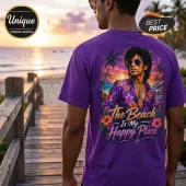 Man wearing a purple t-shirt with a Prince graphic of a beach sunset and text saying The Beach Is My Happy Place.!