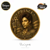 Gold commemorative coin featuring Prince portrait, microphone, Love Symbol, and 1776-2026 text with stars and stripes design.!