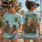 Light blue vintage wash t-shirt featuring Rat Fink character graphics, tropical beach scenes, and surf-themed typography.!