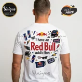 White t-shirt showing back print with Red Bull logos, energy drink cans, racing helmet, and text I have a Red Bull addiction.!