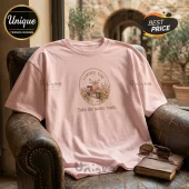 Light pink cotton crew neck t-shirt featuring a vintage scooter graphic, floral illustrations, and Take the scenic route text.!