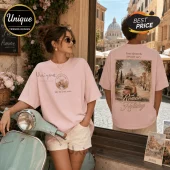 Pink cotton oversized t-shirt with Roman holiday scooter graphic print, featuring front chest logo and back scenic art.!